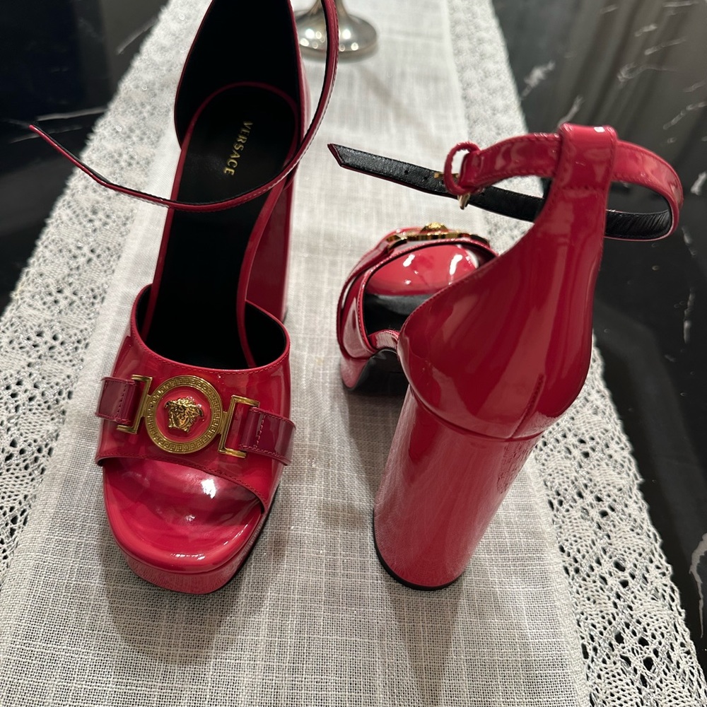 Versace single platform sandals.